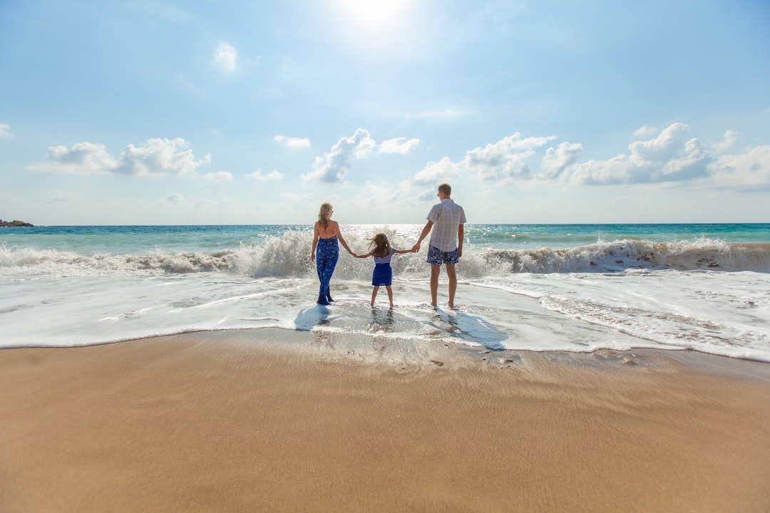 Happy parents reviewing life insurance documents with young children at home